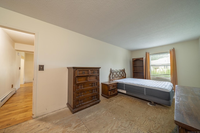 226 Laurel St Apt 4, East Haven, CT 06512 - bedroom with light wood-style flooring and a baseboard radiator