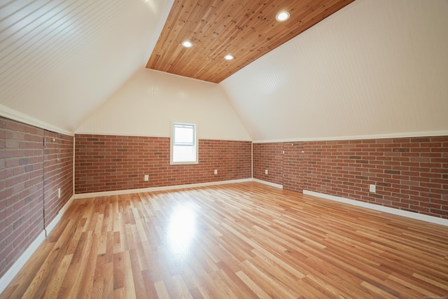 72 Harral Ave, Bridgeport, CT 06604 - additional living space with brick wall, wood finished floors, vaulted ceiling, and recessed lighting