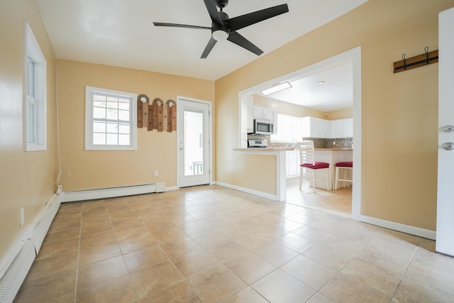 72 Harral Ave, Bridgeport, CT 06604 - unfurnished living room with a baseboard radiator, a ceiling fan, light tile patterned floors, and baseboard heating