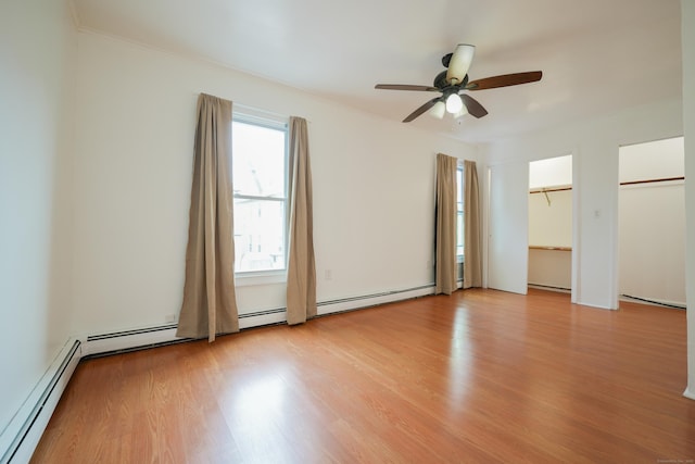 72 Harral Ave, Bridgeport, CT 06604 - unfurnished bedroom featuring light wood-style floors, a baseboard heating unit, two closets, ceiling fan, and crown molding