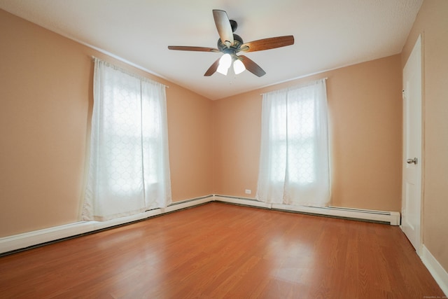 72 Harral Ave, Bridgeport, CT 06604 - spare room featuring healthy amount of natural light, wood finished floors, a ceiling fan, and baseboard heating
