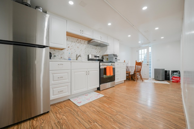 72 Harral Ave, Bridgeport, CT 06604 - kitchen featuring appliances with stainless steel finishes, under cabinet range hood, light wood-type flooring, white cabinets, and recessed lighting