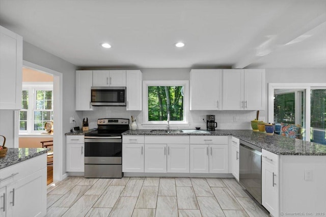 330 Foxwood Rd, Guilford, CT 06437 - kitchen with stainless steel appliances, decorative backsplash, white cabinets, and recessed lighting