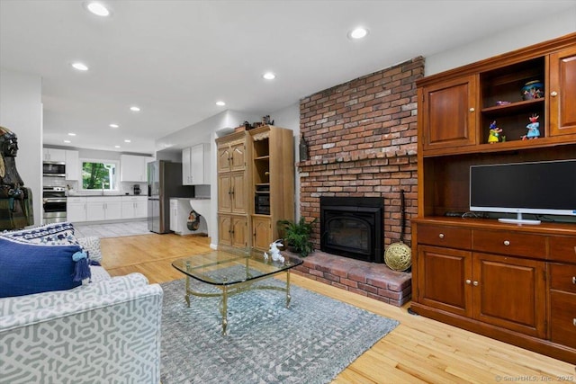 330 Foxwood Rd, Guilford, CT 06437 - living area featuring light wood finished floors, a brick fireplace, and recessed lighting