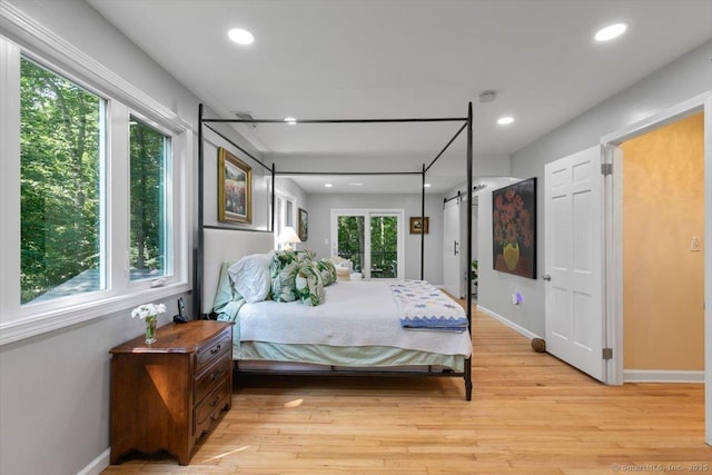 330 Foxwood Rd, Guilford, CT 06437 - bedroom with light wood-style flooring, a barn door, and recessed lighting