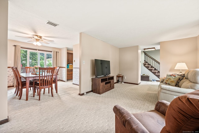 66 Claire St, Bristol, CT 06010 - living room with stairs, light colored carpet, and a ceiling fan