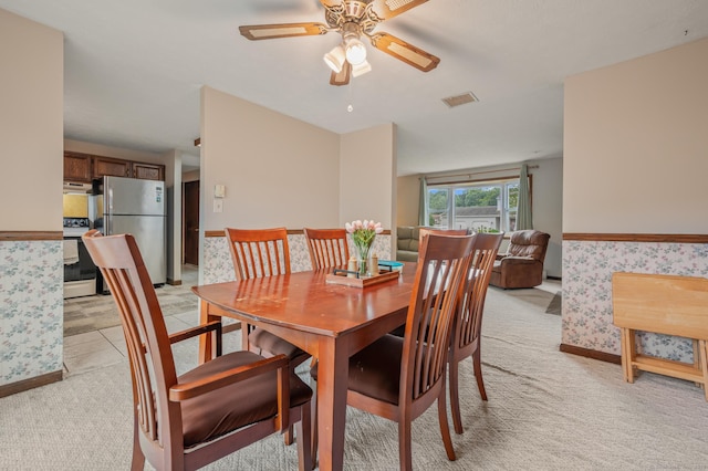 66 Claire St, Bristol, CT 06010 - dining space featuring light colored carpet, a ceiling fan, wallpapered walls, and a wainscoted wall