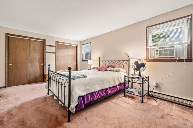 66 Claire St, Bristol, CT 06010 - carpeted bedroom featuring two closets, cooling unit, and a baseboard heating unit