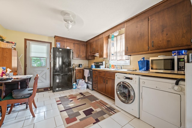 66 Claire St, Bristol, CT 06010 - kitchen with appliances with stainless steel finishes, washer / clothes dryer, light countertops, and light tile patterned floors