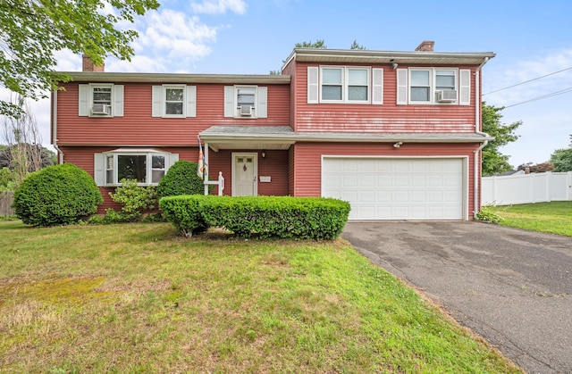 66 Claire St, Bristol, CT 06010 - view of front of house with a chimney, asphalt driveway, a garage, and cooling unit