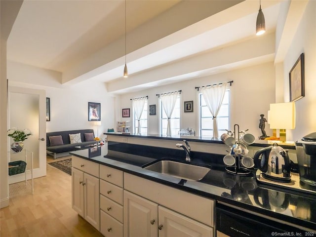 124 Court St Unit 8, New Haven, CT 06511 - kitchen with open floor plan, dark countertops, hanging light fixtures, and light wood-type flooring