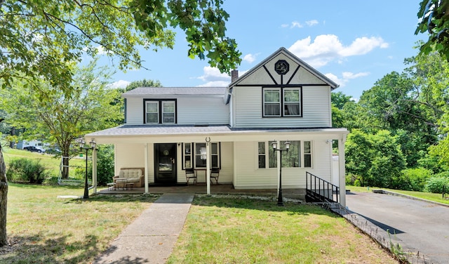 191 Farrell Rd, Waterbury, CT 06706 - view of front of house with covered porch, a front yard, and a chimney