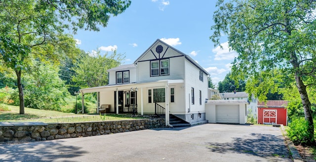 191 Farrell Rd, Waterbury, CT 06706 - view of front of house with an outbuilding, asphalt driveway, and covered porch