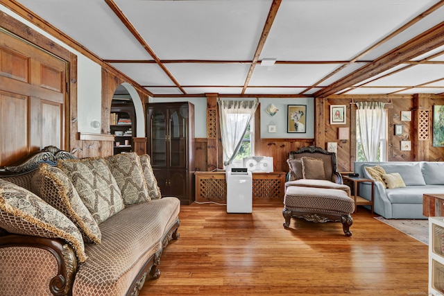 191 Farrell Rd, Waterbury, CT 06706 - living area with wood walls, arched walkways, a wainscoted wall, and light wood finished floors