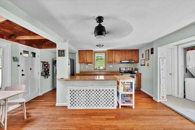 191 Farrell Rd, Waterbury, CT 06706 - kitchen featuring stacked washer / drying machine, electric stove, extractor fan, light wood finished floors, and beam ceiling