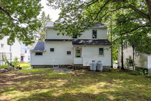21 Whittlesey Ave, Waterbury, CT 06706 - rear view of property featuring a lawn and roof with shingles