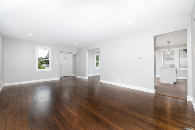 21 Whittlesey Ave, Waterbury, CT 06706 - unfurnished living room featuring healthy amount of natural light, dark wood-style floors, and recessed lighting