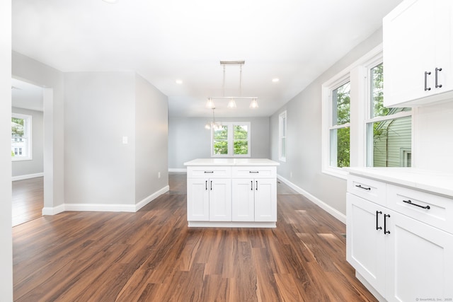 21 Whittlesey Ave, Waterbury, CT 06706 - kitchen with dark wood finished floors, light countertops, white cabinetry, and pendant lighting