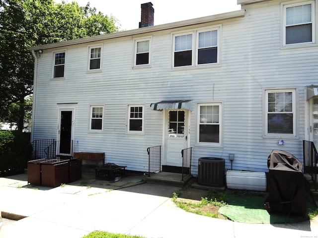 155 Sylvan Knoll Rd, Stamford, CT 06902 - rear view of house featuring a chimney and a patio area