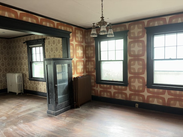 607 Broadview Ter, Hartford, CT 06106 - unfurnished dining area featuring radiator heating unit, wallpapered walls, wood finished floors, and a chandelier