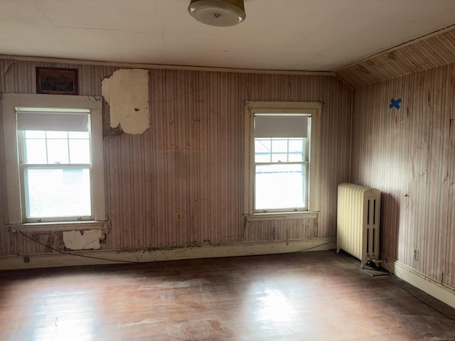 607 Broadview Ter, Hartford, CT 06106 - unfurnished room featuring radiator heating unit, wood finished floors, vaulted ceiling, and wood walls