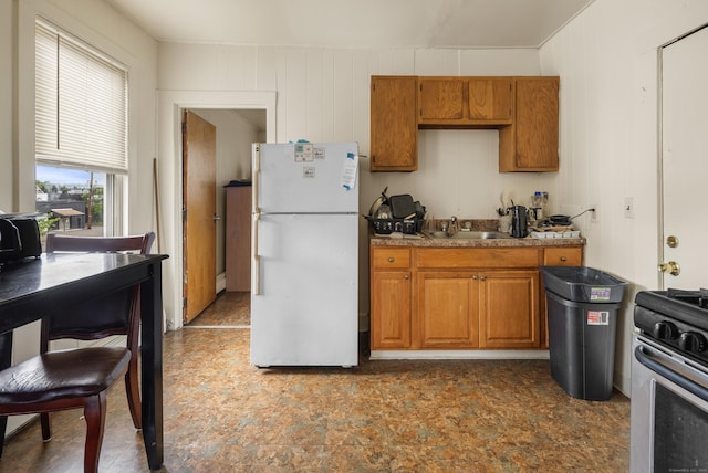 245 Goodrich St, Hamden, CT 06517 - kitchen featuring freestanding refrigerator, stainless steel range oven, brown cabinets, a baseboard heating unit, and light countertops