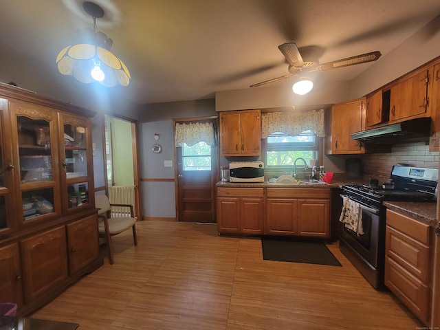 360 Kneeland Rd, New Haven, CT 06512 - kitchen with stainless steel gas stove, under cabinet range hood, white microwave, ceiling fan, and brown cabinets