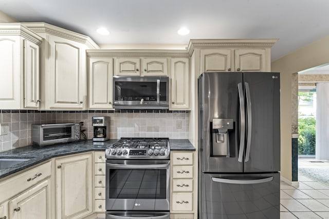4 Quail Run Dr, Danbury, CT 06811 - kitchen featuring appliances with stainless steel finishes, cream cabinets, light tile patterned floors, and backsplash