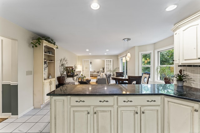 4 Quail Run Dr, Danbury, CT 06811 - kitchen featuring light tile patterned flooring, dark stone countertops, cream cabinets, and recessed lighting