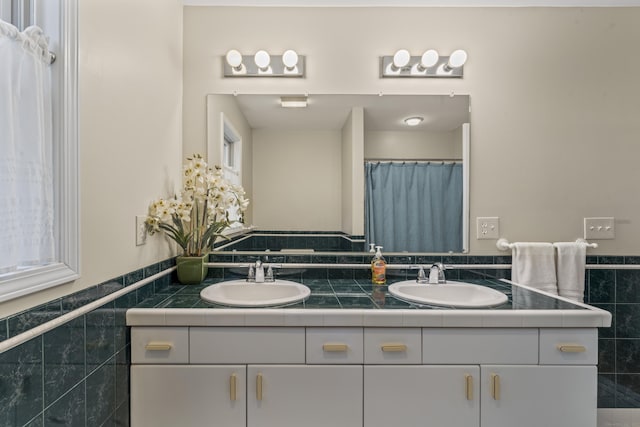 4 Quail Run Dr, Danbury, CT 06811 - full bath featuring double vanity, tile walls, and a wainscoted wall