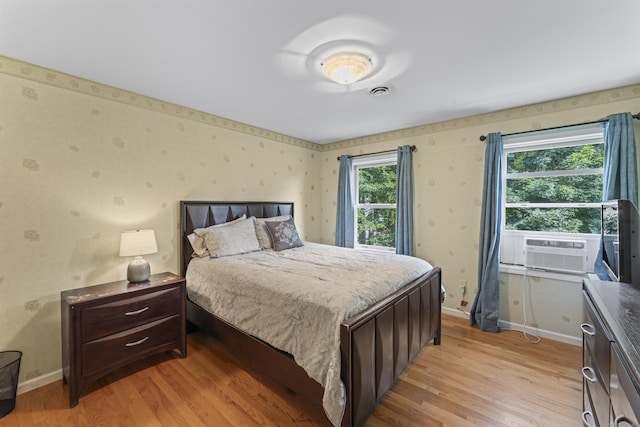 4 Quail Run Dr, Danbury, CT 06811 - bedroom with wallpapered walls, light wood-type flooring, and cooling unit