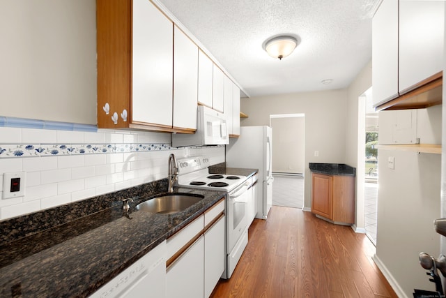 101 W Walk Unit 101, West Haven, CT 06516 - kitchen featuring white appliances, light wood-style flooring, white cabinetry, tasteful backsplash, and a textured ceiling