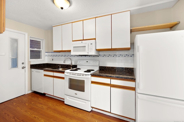 101 W Walk Unit 101, West Haven, CT 06516 - kitchen featuring white appliances, backsplash, wood finished floors, white cabinetry, and a textured ceiling