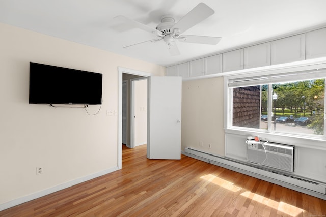 101 W Walk Unit 101, West Haven, CT 06516 - empty room featuring a baseboard radiator, light wood-style flooring, a ceiling fan, and an AC wall unit