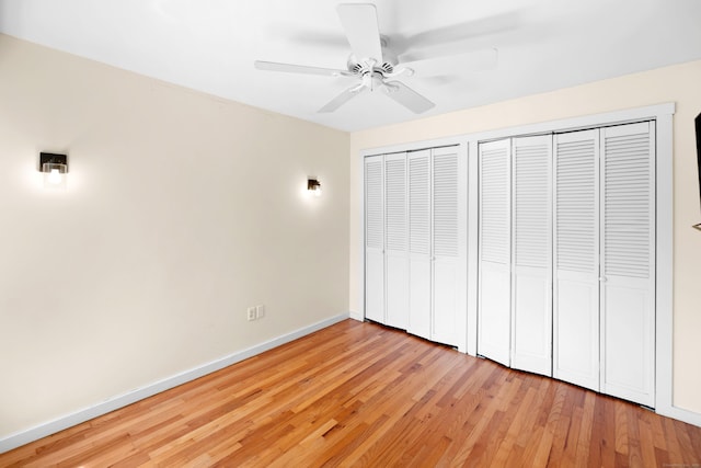 101 W Walk Unit 101, West Haven, CT 06516 - unfurnished bedroom featuring two closets, light wood-style flooring, and ceiling fan