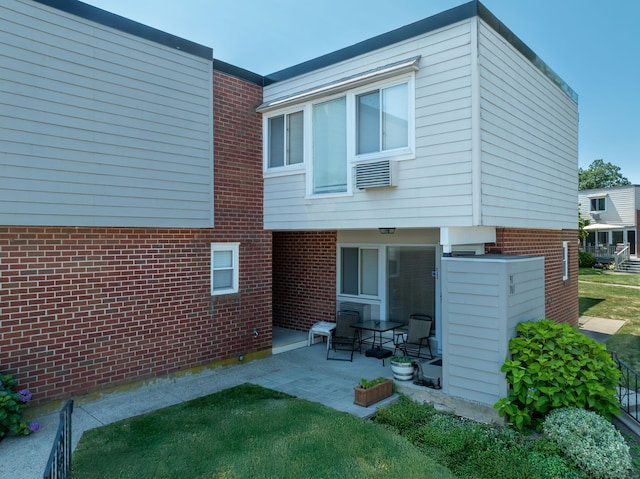 101 W Walk Unit 101, West Haven, CT 06516 - rear view of property featuring brick siding and a patio