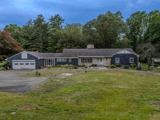 35 Flax Mill Ter, Milford, CT 06461 - view of front of home featuring asphalt driveway, a chimney, a garage, and a front lawn