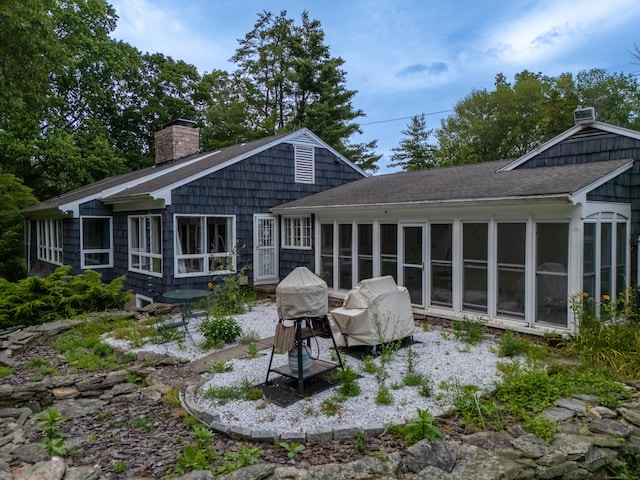 35 Flax Mill Ter, Milford, CT 06461 - back of property featuring a sunroom, a chimney, and a shingled roof
