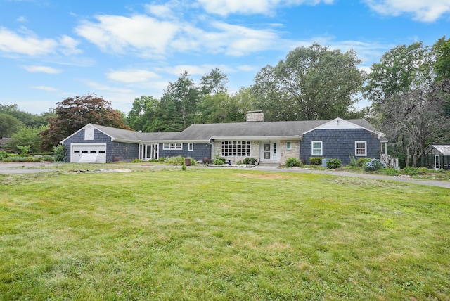 35 Flax Mill Ter, Milford, CT 06461 - view of front of home with a chimney, a front yard, and a garage