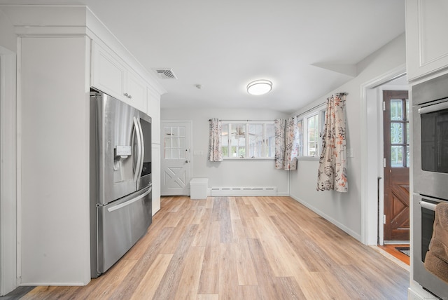 35 Flax Mill Ter, Milford, CT 06461 - kitchen with stainless steel appliances, a baseboard heating unit, light wood-type flooring, and white cabinetry