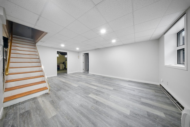 35 Flax Mill Ter, Milford, CT 06461 - finished basement featuring baseboard heating, stairway, wood finished floors, recessed lighting, and a paneled ceiling
