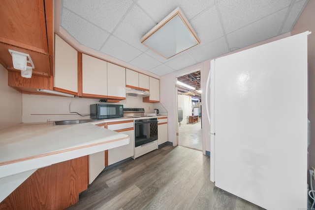 35 Flax Mill Ter, Milford, CT 06461 - kitchen featuring white appliances, under cabinet range hood, wood finished floors, white cabinets, and a drop ceiling