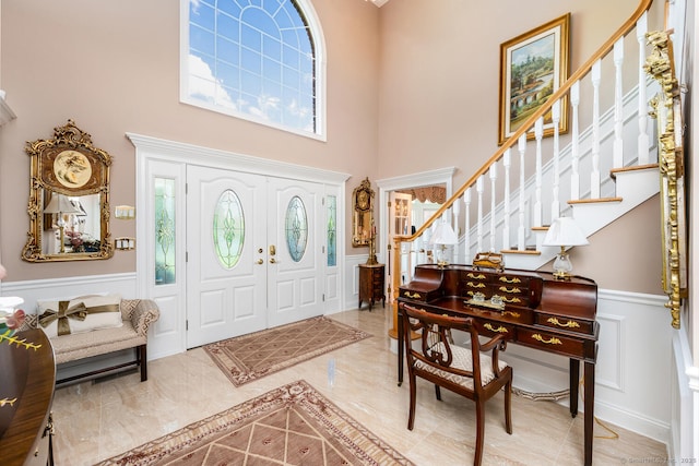 90 Soundview Ave, Shelton, CT 06484 - entrance foyer with a decorative wall, a high ceiling, a wainscoted wall, and stairs