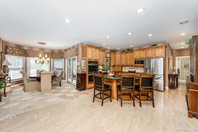 90 Soundview Ave, Shelton, CT 06484 - kitchen with appliances with stainless steel finishes, a chandelier, a kitchen breakfast bar, recessed lighting, and a center island