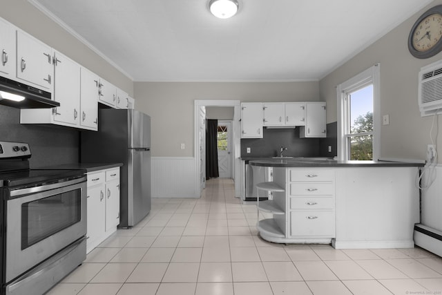 1691 State St, Hamden, CT 06517 - kitchen featuring stainless steel appliances, under cabinet range hood, dark countertops, a wainscoted wall, and white cabinetry