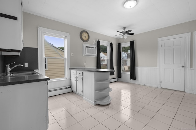 1691 State St, Hamden, CT 06517 - kitchen featuring a baseboard heating unit, a wall unit AC, a ceiling fan, a peninsula, and white cabinets