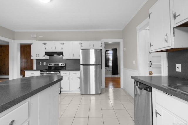 1691 State St, Hamden, CT 06517 - kitchen with stainless steel appliances, under cabinet range hood, dark countertops, wainscoting, and ornamental molding