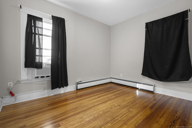 1691 State St, Hamden, CT 06517 - spare room featuring a baseboard radiator and wood finished floors