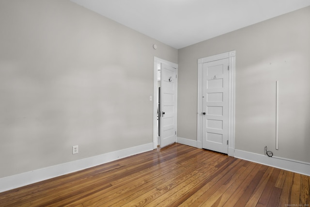 1691 State St, Hamden, CT 06517 - empty room with baseboards and hardwood / wood-style flooring