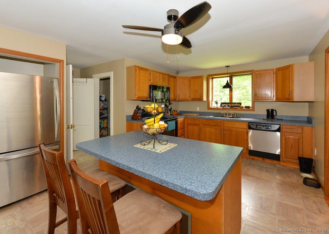 215 White Birch Dr, Southbury, CT 06488 - kitchen featuring black appliances, ceiling fan, a kitchen bar, a center island, and dark countertops